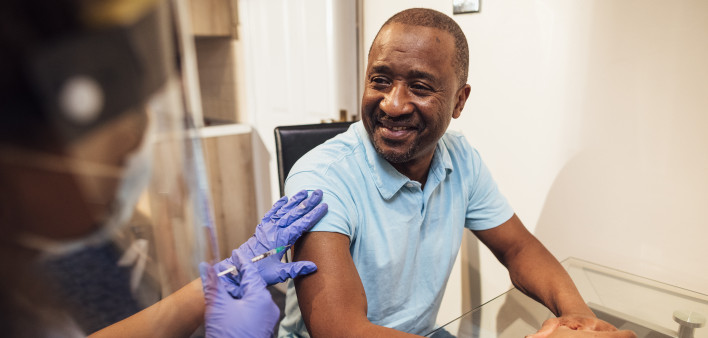 black man getting coronavirus vaccine