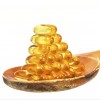 Vitamin D Capsules on wooden spoon