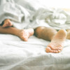 in bed sleeping feet showing
