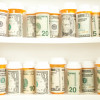 pill bottles with money as labels cost of healthcare