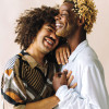 two gay men embrace and laugh