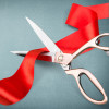 scissors cutting red ribbon