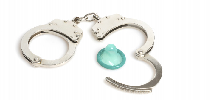 handcuffs and a blue condom
