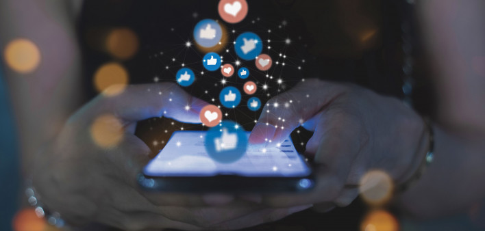 social media hands on phone with icons