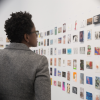 Viewers take in the 1,662 postcards on display.