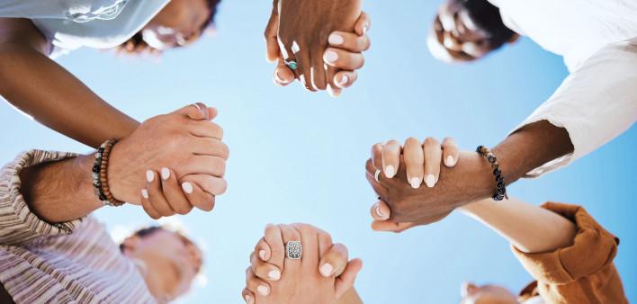 group of people holding hand to form a circle support