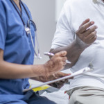 nurse talking to black doctor